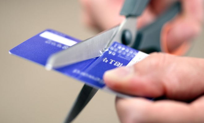 cutting a credit card with scissors | John Kenney & Associates PLLC Kitsap